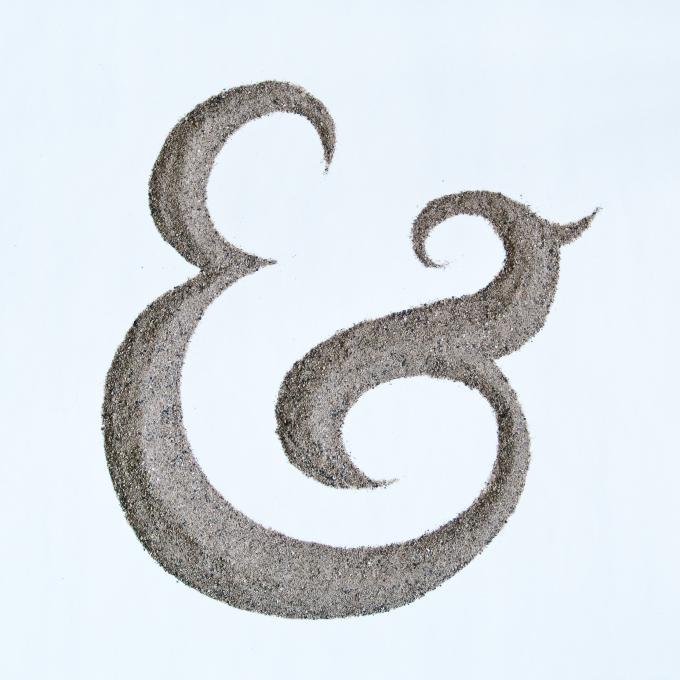 illustration of an ampersand drawn from actual sand